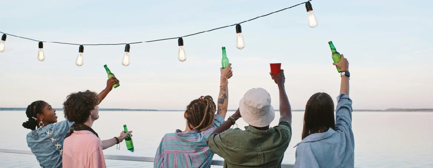 picture of people toasting drinks off a pier